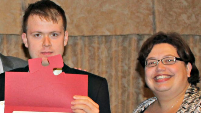 David Lee Cook, Jr., and Autism Delaware Executive Director Teresa Avery at a scholarship awards dinner.