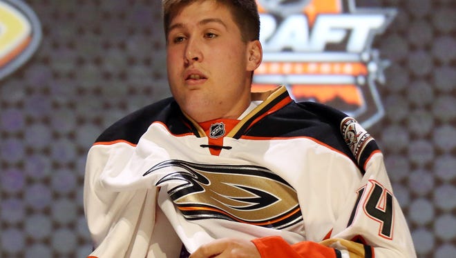Nick Ritchie puts on a team sweater after being selected as the No. 10 overall pick by the Anaheim Ducks.
