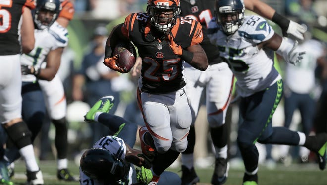 Cincinnati Bengals running back Giovani Bernard (25) breaks away from tackles as he makes a carry in the fourth quarter of the NFL Week 5 game between the Cincinnati Bengals and the Seattle Seahawks at Paul Brown Stadium in Cincinnati, on Sunday, Oct. 11, 2015. The Bengals advanced to 5-0 with a 27-24 overtime win over Seattle.