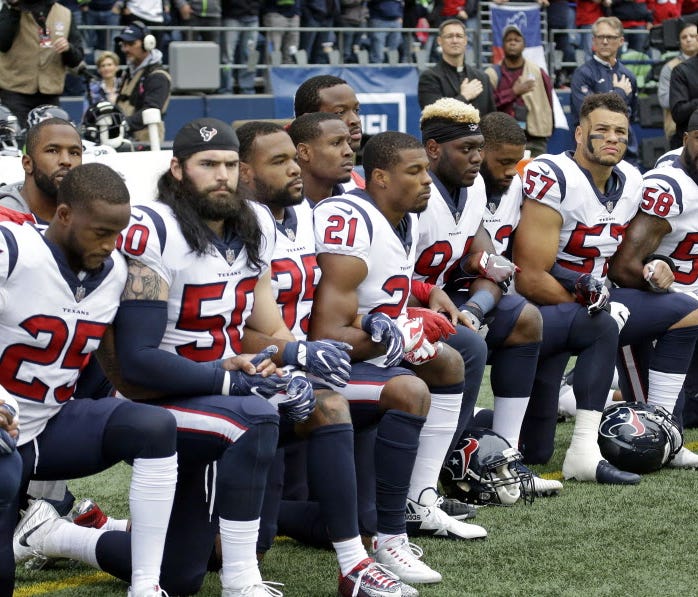Houston Texans players kneel during the national anthem before an Oct. 29 game in Seattle.