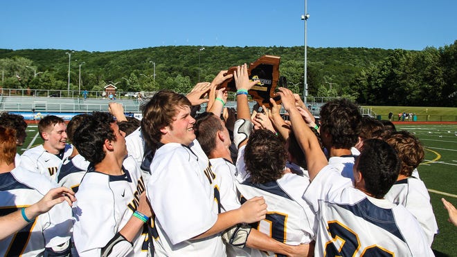 Victor players celebrate winning the Class B boys lacrosse state championship.