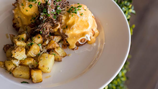 A brunch specialty at City Cellar in West Palm's Rosemary Square: short rib Benedict with cheddar biscuit, poached egg, Sriracha hollandaise, breakfast potatoes and shaved Manchego.
