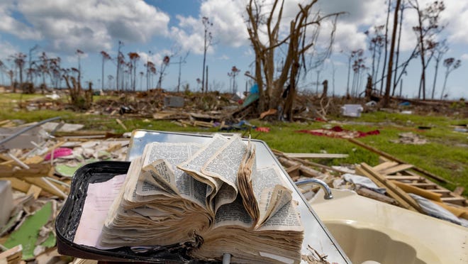 Judymae Feaster's 25-year-old bible dries on the bathroom sink of her home, destroyed by Hurricane Dorian, in Rocky Creek, Bahamas on September 17, 2019.