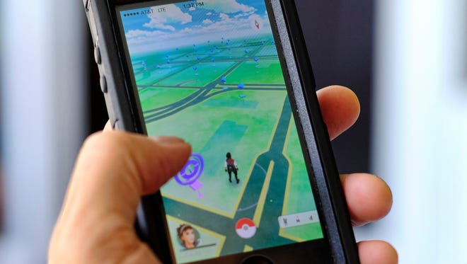 Pokemon Go is displayed on a cell phone in Los Angeles on Friday, July 8, 2016. Just days after being made available in the U.S., the mobile game Pokemon Go has jumped to become the top-grossing app in the App Store. And players have reported wiping out in a variety of ways as they wander the real world, eyes glued to their smartphone screens, in search of digital monsters.