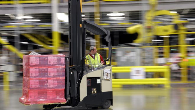A forklift operator moves a pallet of goods at an Amazon.com fulfillment center in DuPont, Wash. This year, Amazon has been making an aggressive push to offer same-day delivery to its $99 annual Prime loyalty club members.