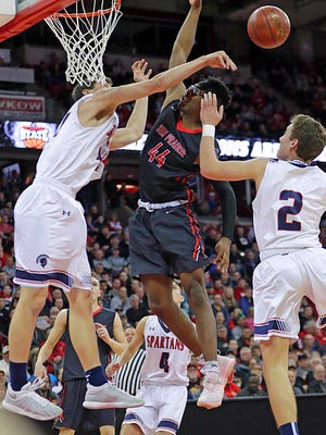 Brookfield East's Patrick Cartier slaps away a shot by Sun Prairie's Marlon Ruffin during a Division 1 semifinal Friday night.