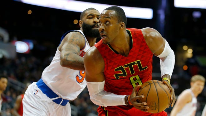 Atlanta Hawks center Dwight Howard (8) drives to the basket as New York Knicks center Kyle O'Quinn (9) defends during Sunday's game.