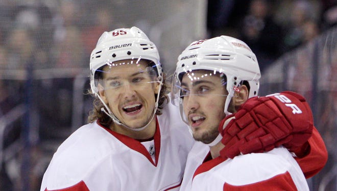 Detroit Red Wings' Tomas Jurco, right, and Danny DeKeyser celebrate Jurco's goal against the Columbus Blue Jackets' during the third period of an NHL hockey game Tuesday, Nov. 18, 2014, in Columbus, Ohio. The Red Wings beat the Blue Jackets 5-0.