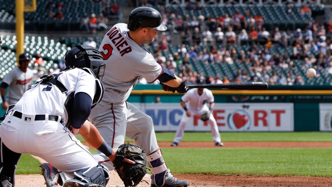 Twins second baseman Brian Dozier (2) hits a two-run single in the second inning of the Tigers' 5-1 loss Thursday at Comerica Park.