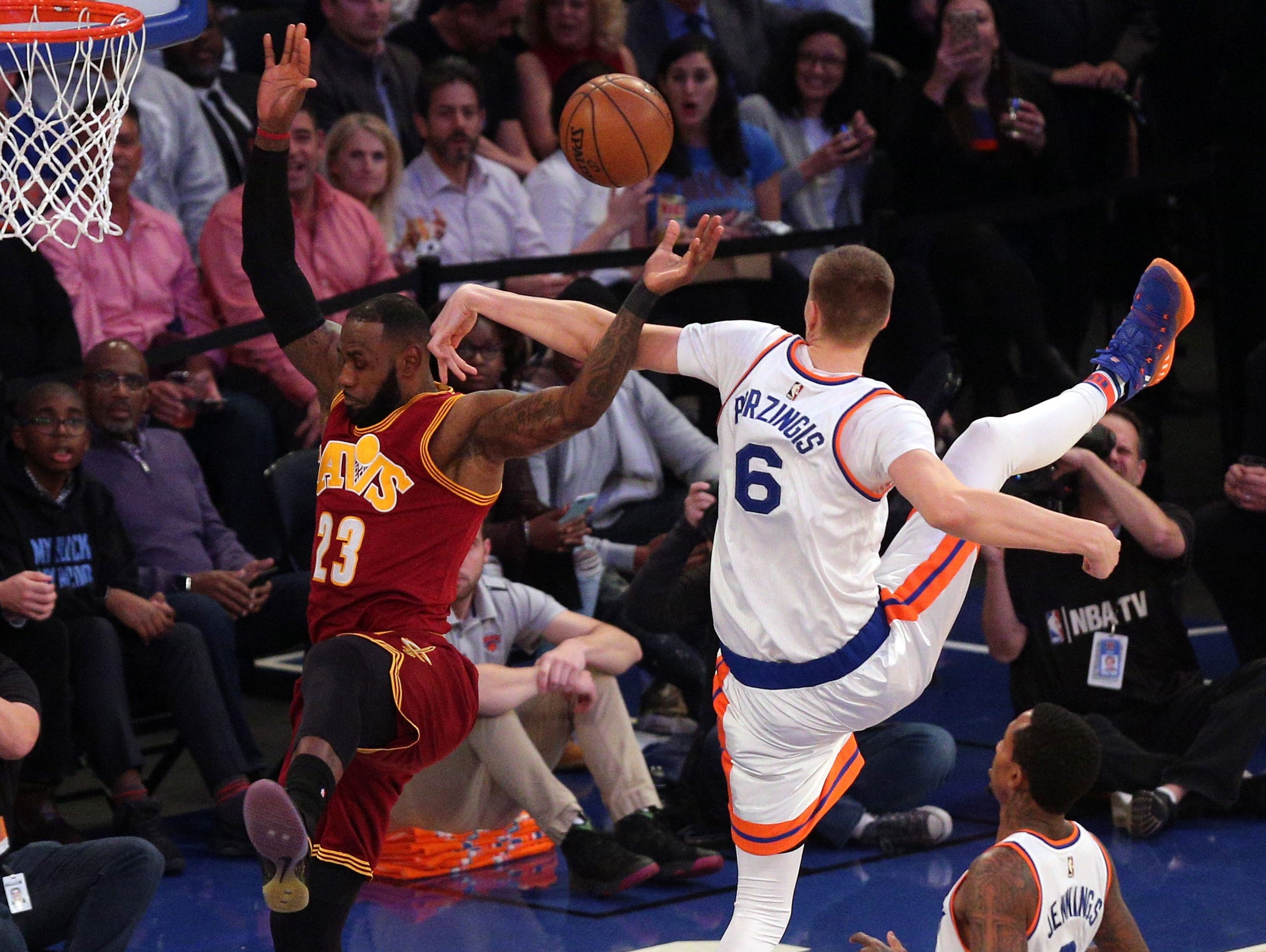 Dec. 7, 2016: Knicks defender Kristaps Porzingis (6) fouls Cavaliers forward LeBron James (23) on a first-half drive at Madison Square Garden. James shook off the hit to score 25 points in a Cleveland rout.
