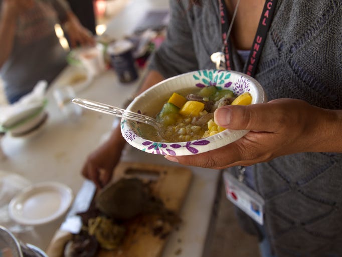 Participants eat mutton stew and enjoy other food Wednesday