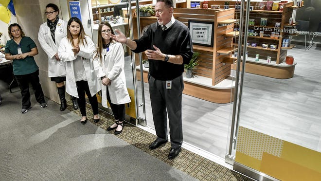 St. Catherine Hospital CEO Scott Taylor, right, talks about Centura Health creating a pharmacy in Siena Medical Clinic in October 2019, during the official opening ceremony for the facility. The pharmacy was dedicated Friday in honor of Taylor, who is retiring July 1.