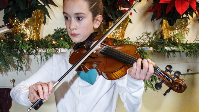 Maya Schimelfenyg plays music during the Yuletide Faire in 2015 at the Prairie Hill Waldorf School. This year's enchanting event will run Friday, Nov. 17 and Saturday, Nov. 18.