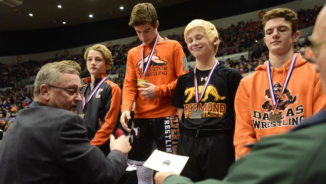 Silverton freshman Kaden Kuenzi accepts his state championship medal at the OSAA State Wrestling Championships at the Veterans Memorial Coliseum in Portland, Ore., on February 25, 2017. (Photo by: Alex Milan Tracy)