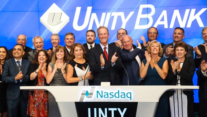 Unity Bank President-CEO James A. Hughes, center, is pictured with bank staff and directors during a recent visit to Nasdaq MarketSite in Times Square. The community bank has been named one of the 2017 Best Places to Work in New Jersey in the small/medium category. NJBIZ has produced the awards program since 2005.