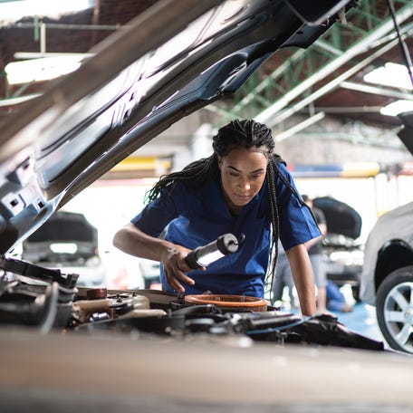 Mechanic working on a car.