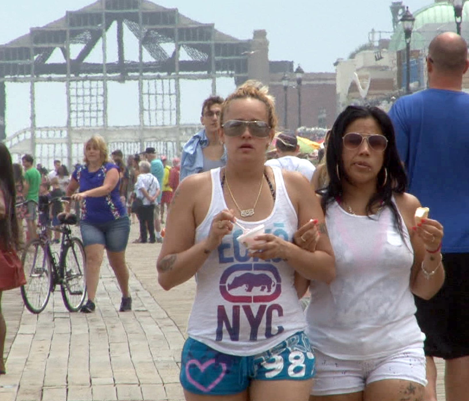 Jessica Acevedo (left) and her girlfriend Diane Ortiz, Perth Amboy, walk on the Asbury Park boardwalk Thursday, July 7, 2016.
