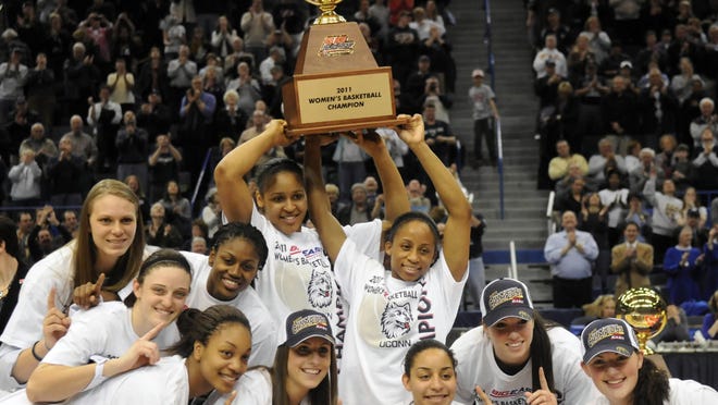 The UConn women's basketball team hoists the Big East championship trophy after defeating Notre Dame, 73-64, at the XL Center on March 8, 2011.