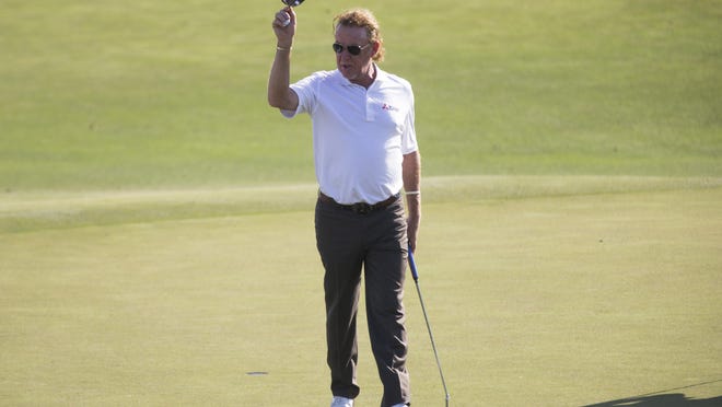 Miguel Angel Jimenez lifts his visor as he birdies the last hole of the day to finish tied for the lead with a score of seven-under par after the first round of The Chubb Classic at TwinEagles Club on Friday.