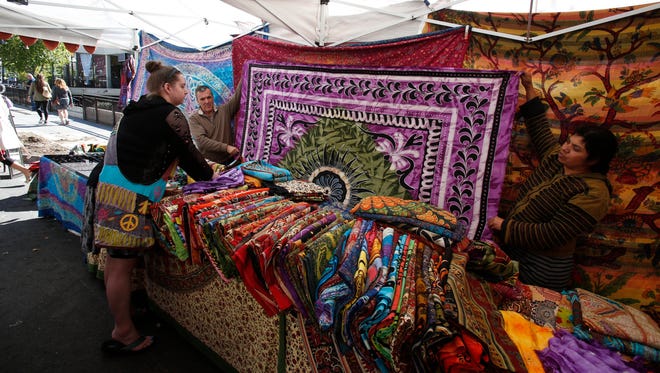 A customer browses fabrics from Namaste Imports at the Nyack Street Fair on Oct. 11, 2015. This year, the Nyack Famous Street Fair will be held Oct. 7.