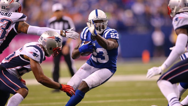 Indianapolis Colts running back Frank Gore (23) rushes the ball into a hole in the New England defense during first half action of an NFL football game Sunday, Oct. 18, 2015, at Lucas Oil Stadium.