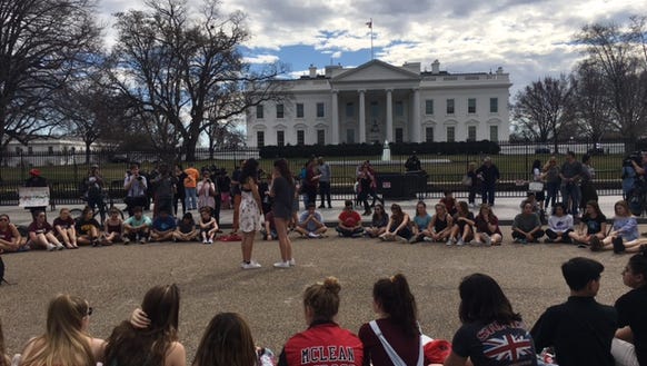 High school students form a circle in front of the