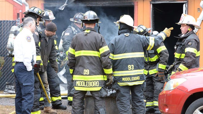 FILE - In this Feb. 5, 2020, file photo, Middleboro firefighters, including Fire Chief Lance Benjamino, left, are seen at the scene of a fire. The department extinguished a camper fire early Tuesday morning, Oct. 20, 2020.