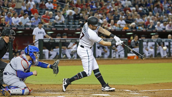 Arizona Diamondbacks' Brandon Drury hits a two-run double against the Los Angeles Dodgers during the first inning of their MLB game Tuesday, Aug. 29, 2017, in  Phoenix, Ariz.