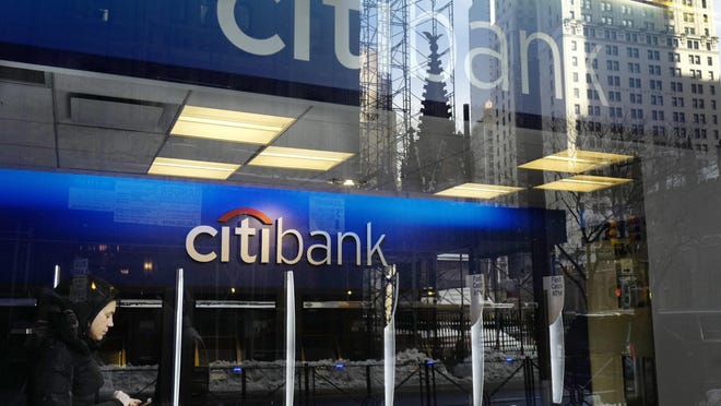 FILE - In this Thursday, March 16, 2017, file photo, a customer enters a Citibank branch, in New York. President Donald Trumpâs decision to abandon the Paris climate agreement will have different impacts on different US companies, depending on what they make and whether they do business overseas. Citibank, which had urged Trump to keep the U.S. in the accord, said Friday, June 9, that it would âremain very focused on our own efforts to protect the environment,â including its commitment to finance $100 billion in clean energy, infrastructure and technology projects. (AP Photo/Mark Lennihan, File)