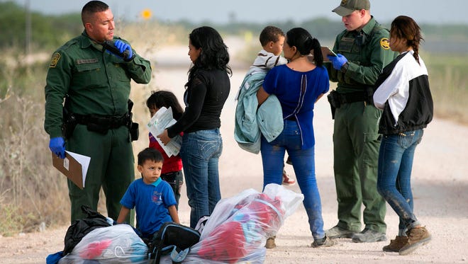 Women and children from Honduras are apprehended by Border Patrol near the Anzalduas International Bridge not far from the border with Mexico at the Rio Grande river in Mission, Texas, on June 21, 2014.