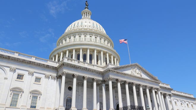 U.S. Capitol under a blue sky.