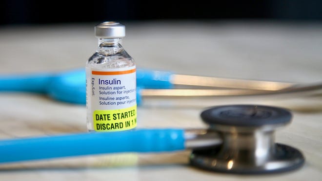 Vial of insulin with stethoscope.