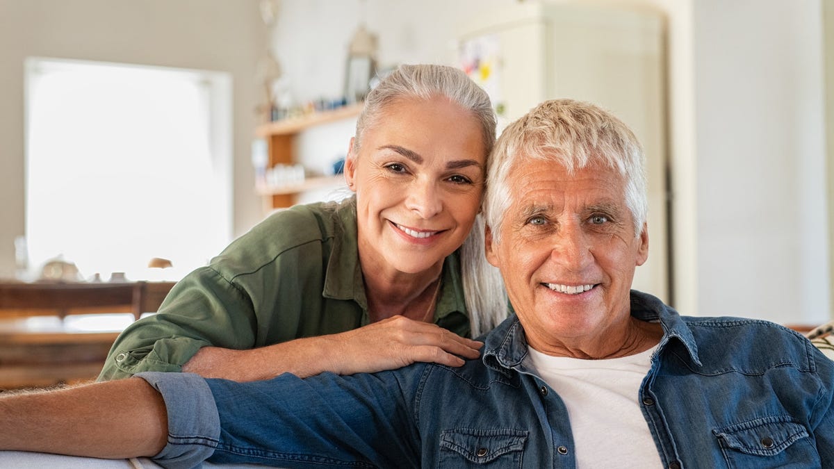 A smiling older couple in their home