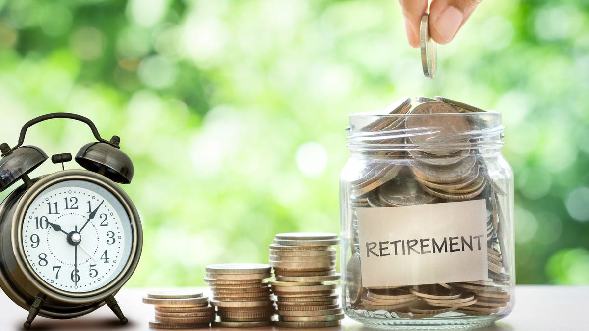 Jar filled with coins labeled retirement.