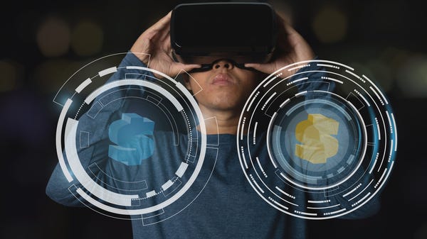 A person holding virtual reality goggles with imag