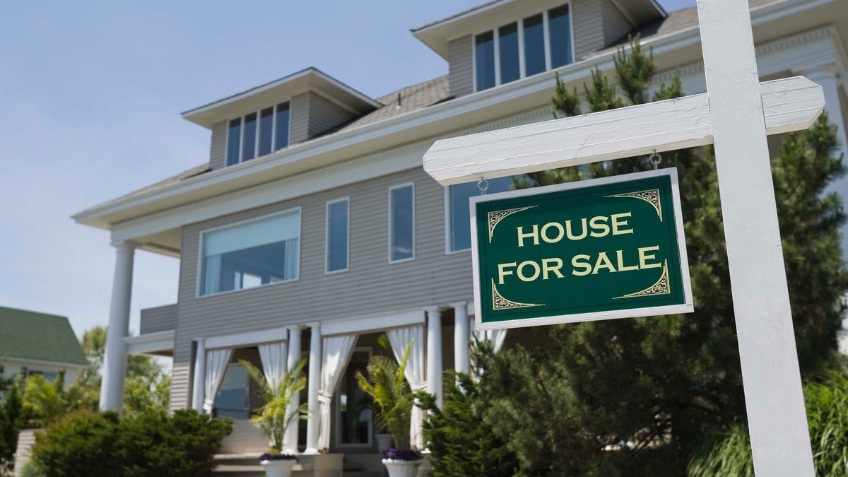 House with a for-sale sign outside.