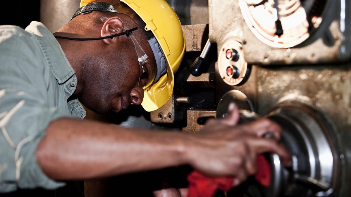 Factory worker at a macine.