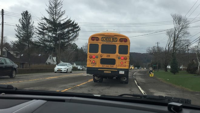 A Chenango Forks school bus travels on Route 12 early Thursday, April 26, 2018, while being followed by a Broome County Sheriff's deputy to catch drivers who illegally pass the bus.