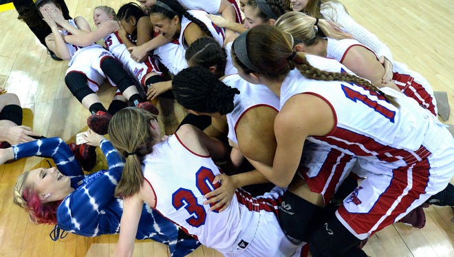Members of the Mercer County basketball team pile on each other following their victory over Franklin County to win the Kentucky girls' high school state basketball championship Sunday, March. 12, 2017, in Newport, Ky. (AP Photo/Timothy D. Easley)