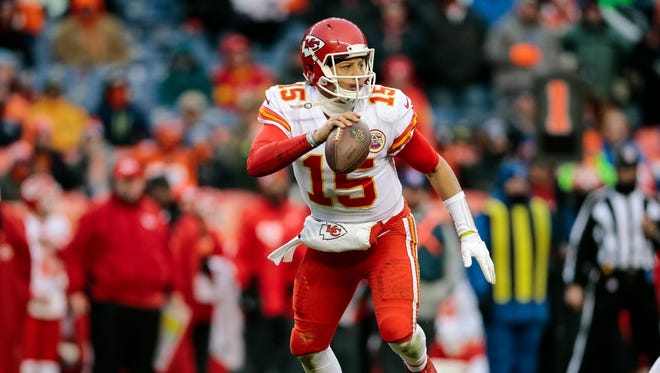 Kansas City Chiefs quarterback Patrick Mahomes (15) scrambles in the back field against the Denver Broncos at Sports Authority Field at Mile High.