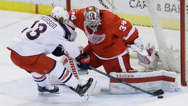 Detroit Red Wings goalie Petr Mrazek, right, stops a shot by Columbus Blue Jackets right wing Cam Atkinson during a shoot-out Feb. 23, 2016, in Detroit.
