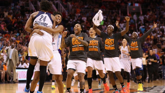 Eastern Conference All-Star Angel McCoughtry #35 (second from left) of the Atlanta Dream and Tamika Catchings #24 (L) of the Indiana Fever celebrate after defeating the Western Conference All-Stars 125-124 in the WNBA All-Star Game at US Airways Center on July 19, 2014 in Phoenix, Arizona.