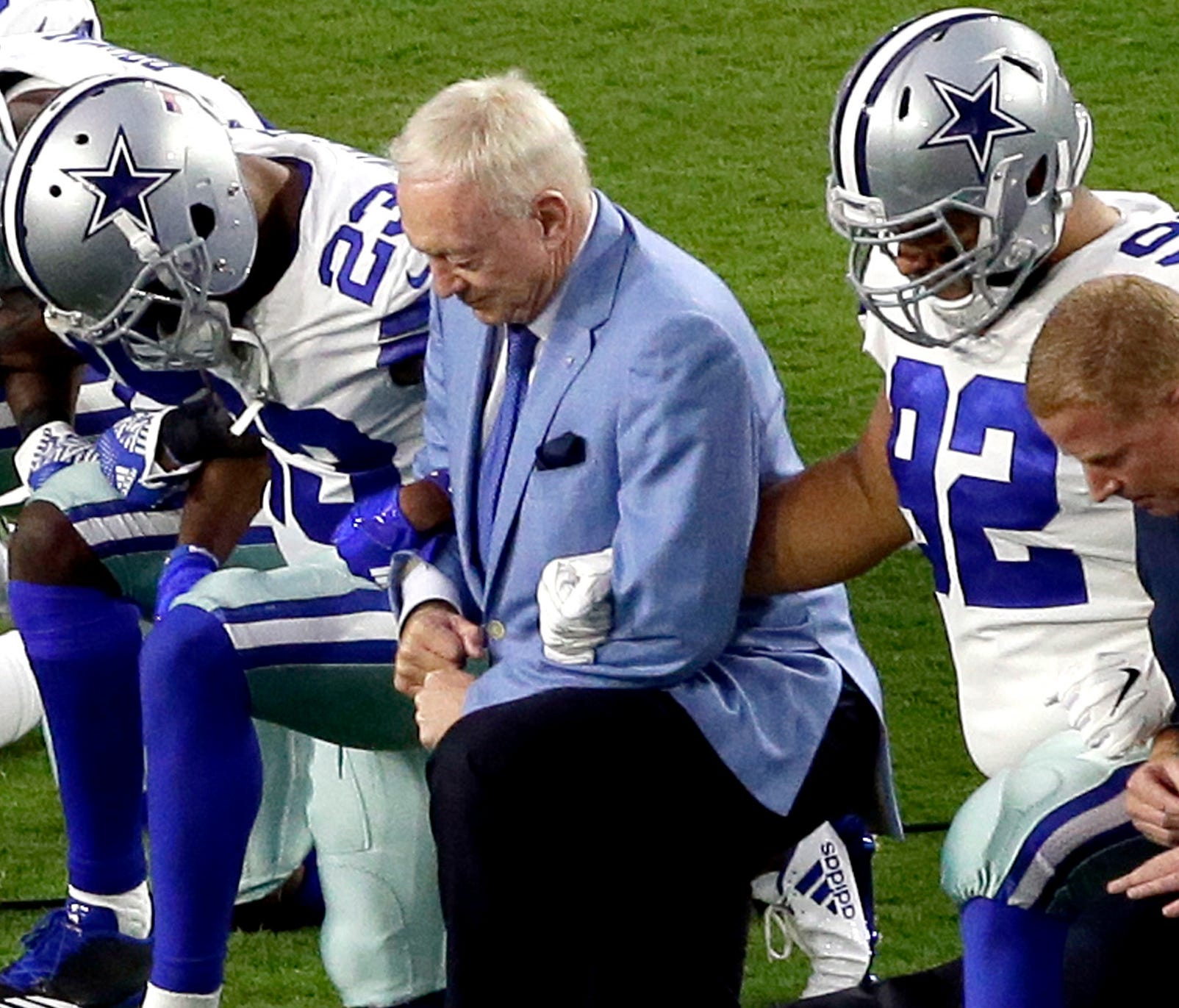 The Dallas Cowboys, led by owner Jerry Jones, take a knee prior to the national anthem.