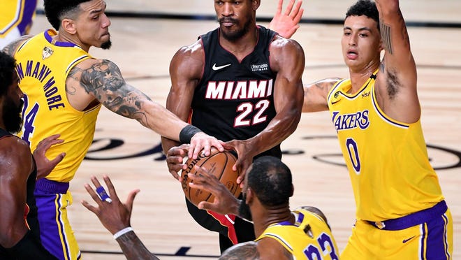 Lakers guard Danny Green, left, knocks the ball from Heat forward Jimmy Butler during the NBA finals Game 1 on Wednesday.