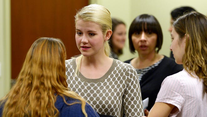 Elizabeth Smart, center, appeared earlier this year at a hearing in support of a proposed Utah measure to teach schoolchildren what to do if they are kidnapped or abused.