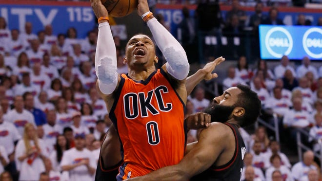 FILE - In this April 23, 2017 file photo, Oklahoma City Thunder guard Russell Westbrook (0) shoots between Houston Rockets guard Patrick Beverley, rear, and guard James Harden, right, in the fourth quarter of Game 4 of a first-round NBA basketball playoff series in Oklahoma City. Westbrook will join Houston’s James Harden and San Antonio’s Kawhi Leonard as finalists for the league’s MVP award. The winner will be announced Monday, June 26, at the inaugural NBA Awards show. (AP Photo/Sue Ogrocki, File)
