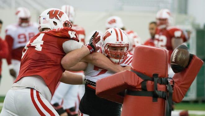 Offensive linemen Brett Connors, left, and nose tackle Gunnar Roberge (74) battle each other during spring practice.