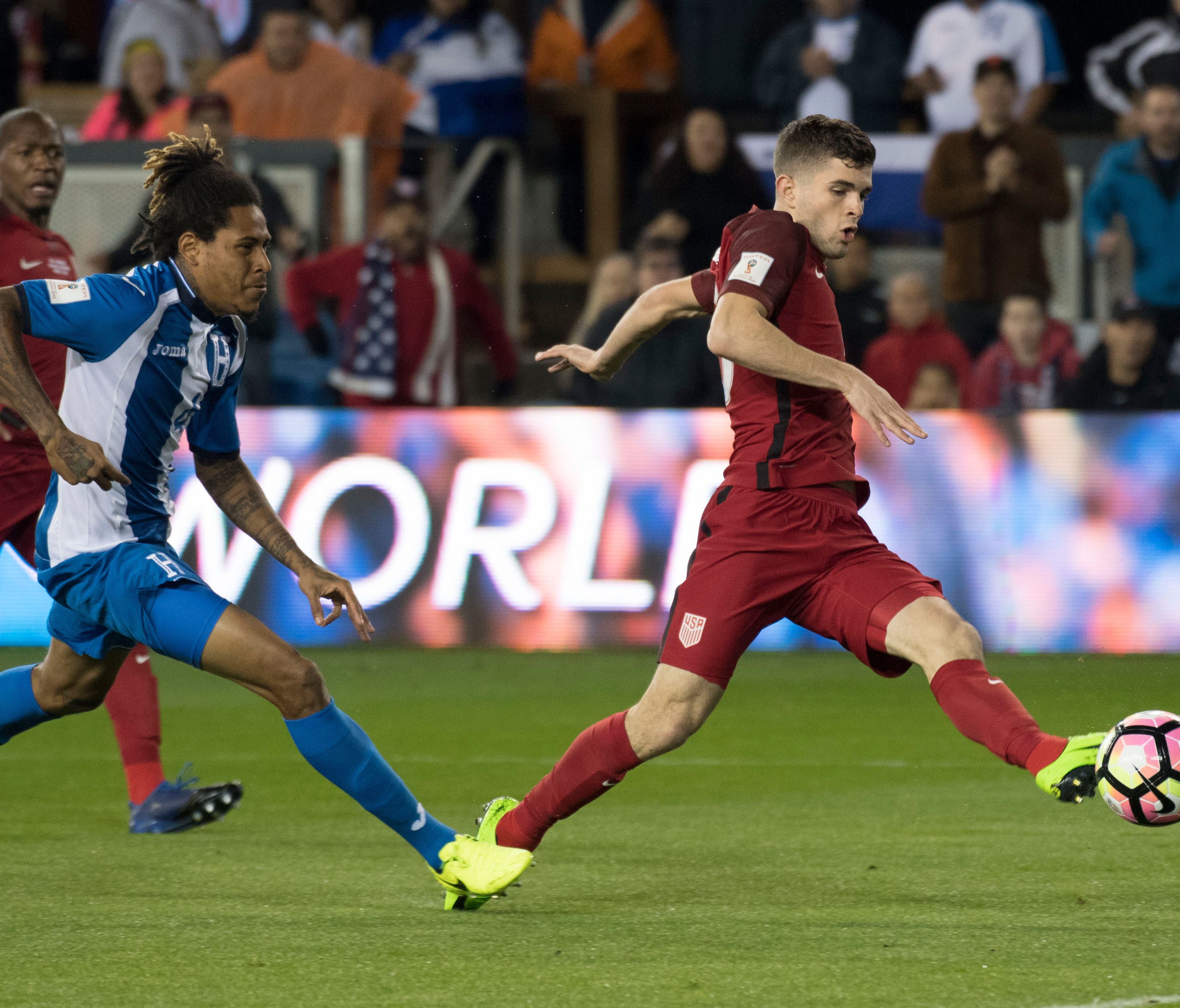 United States midfielder Christian Pulisic (10) kicks the ball against Honduras defender Henry Figueroa (4) during the first half of the Men's World Cup Soccer Qualifier at Avaya Stadium.