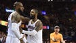 LeBron James is greeted by Kyrie Irving as a fan reacts
