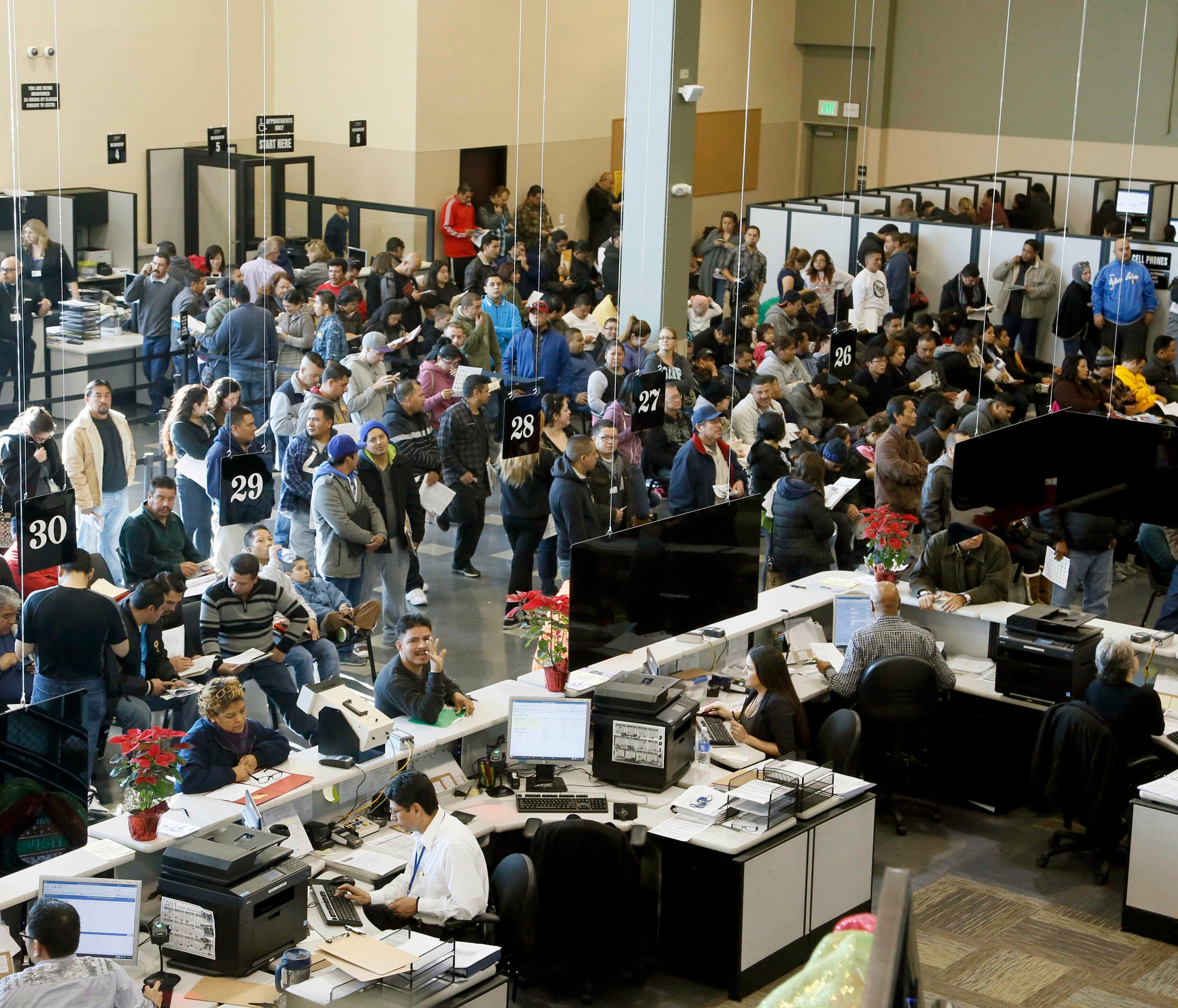 In this Jan. 2 file photo, people line up at a California Department of Motor Vehicles office to register for drivers licenses in Stanton.